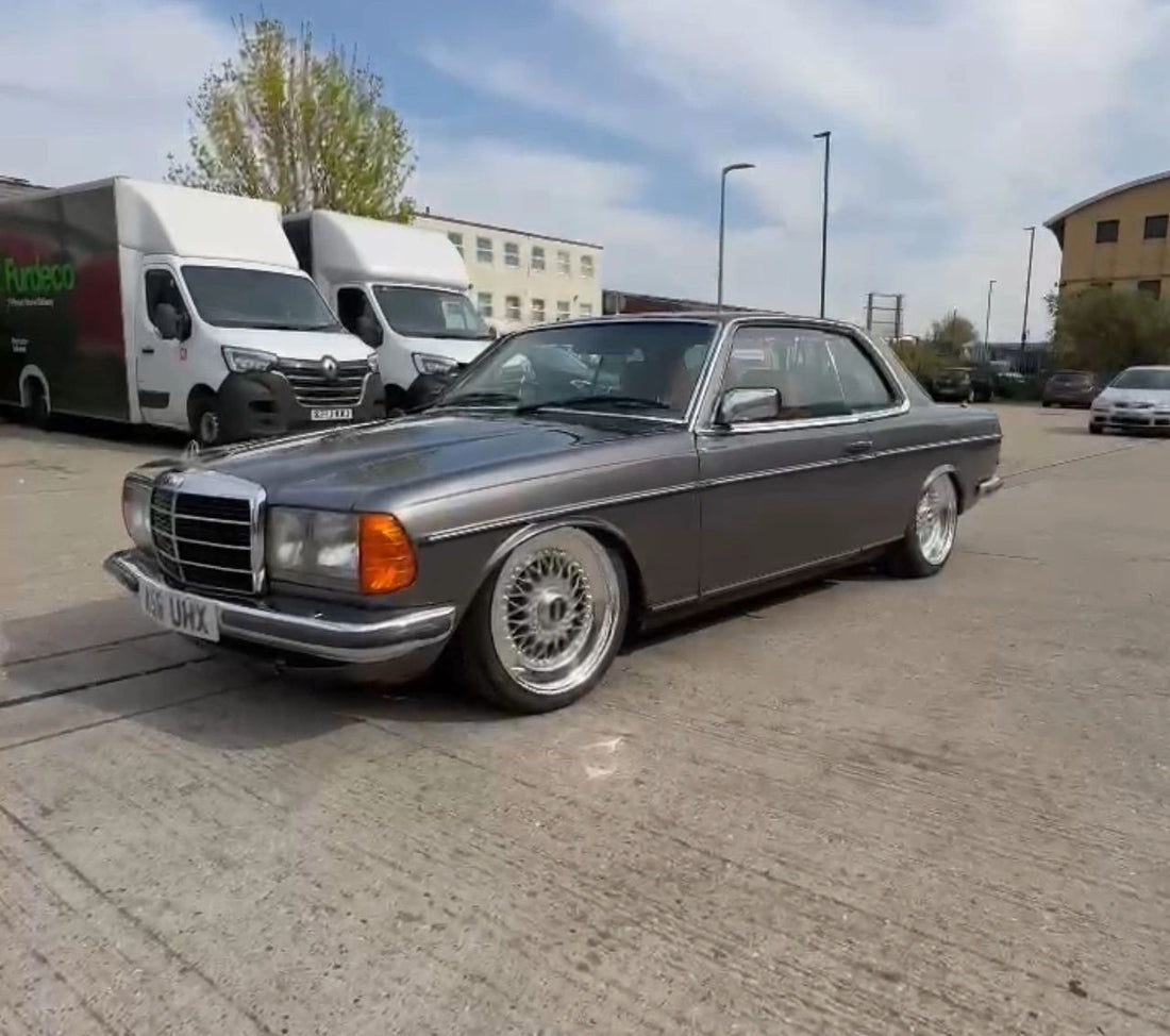 Grey classic Mercedes coupe sitting low on mesh wheels