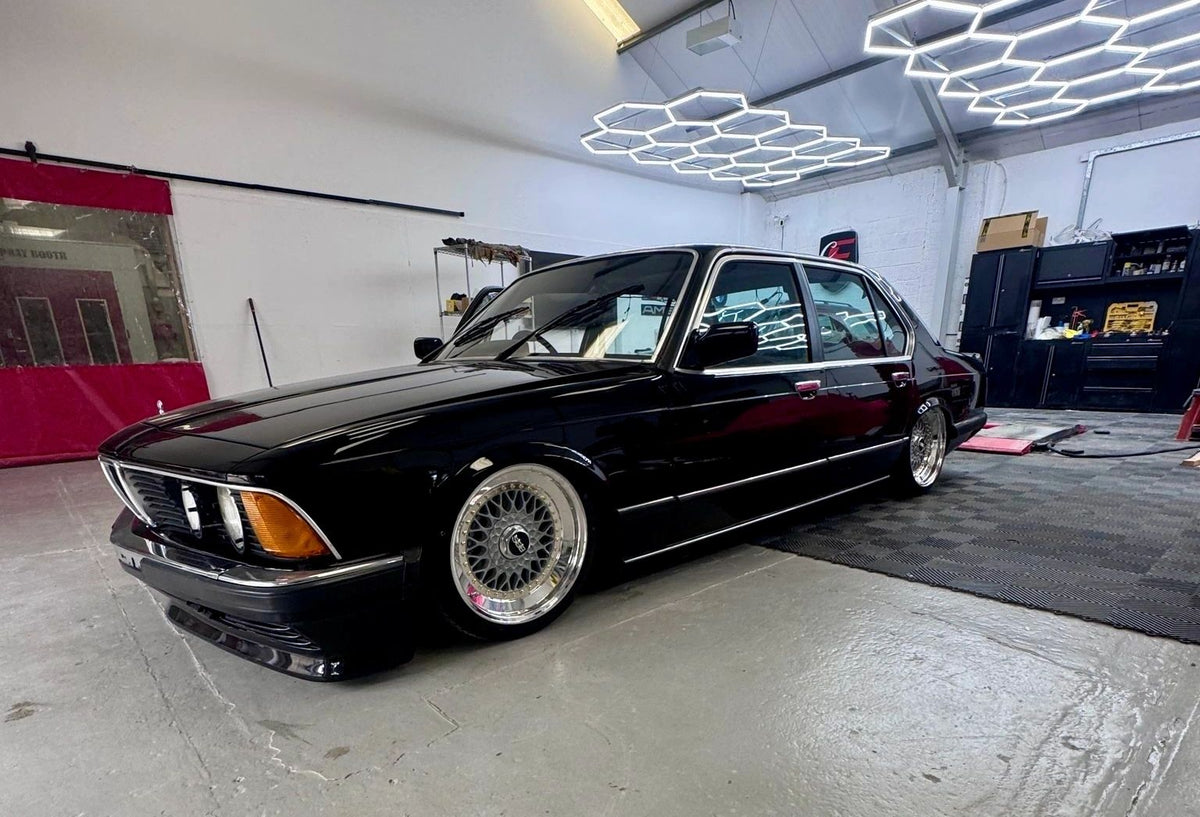 Black BMW E23 7 Series on custom wheels
