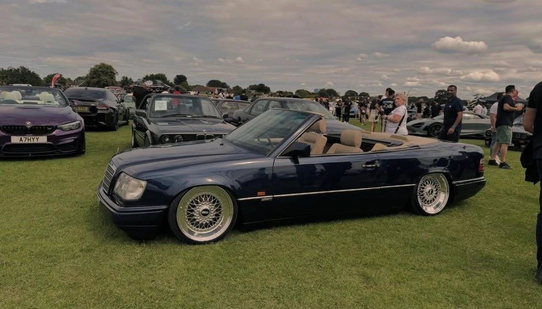 Dark blue classic Mercedes cabriolet with a tan interior and custom wheels