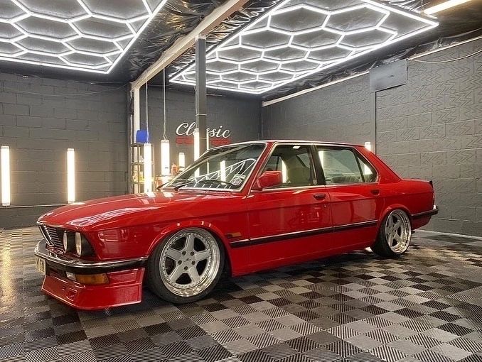 Red classic BMW finished inside the illuminated Classic Custom workshop